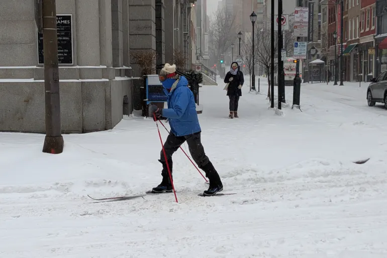 أمريكي يتزلج على الثلوج مستخدمًا وسيلة نقل بديلة بعد تعطل السيارات