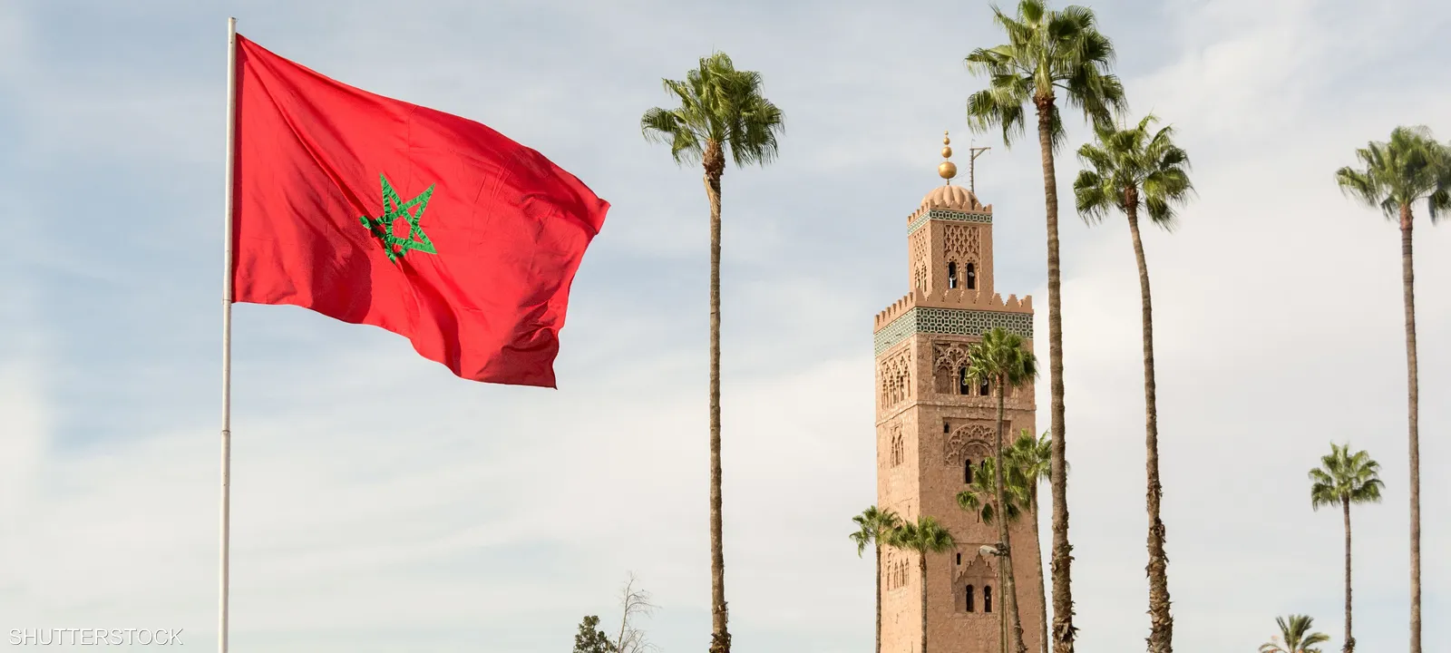 علم المغرب يرفرف فوق مبانٍ حديثة تمثل التحول الرقمي والتقنيات الحديثة